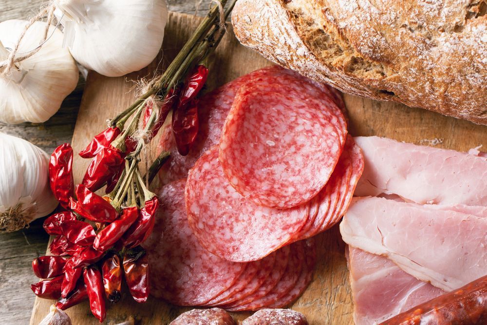 A Wooden Cutting Board Topped With Products — Corrado & Frank Distributors in Fairy Meadow, NSW