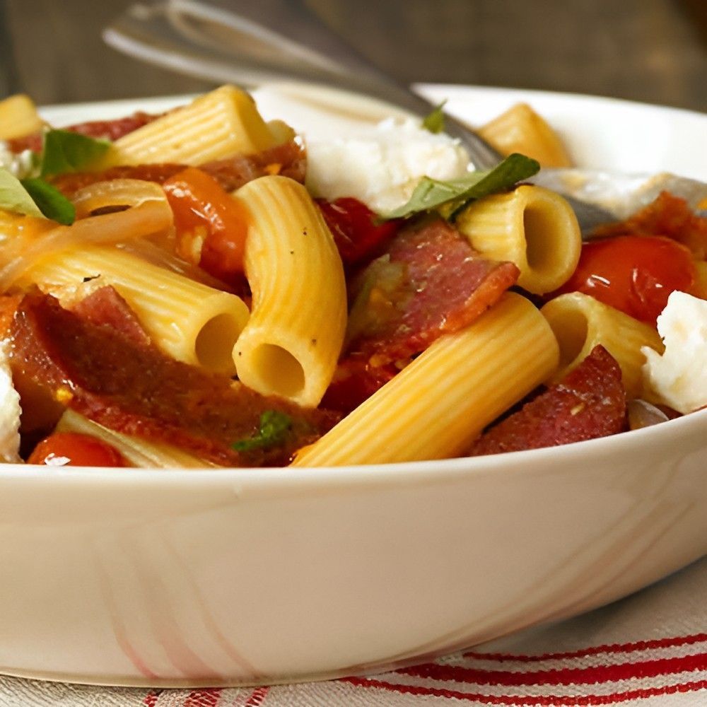 A White Bowl Filled With Pasta Tomatoes and Cheese — Corrado & Frank Distributors in Fairy Meadow, NSW