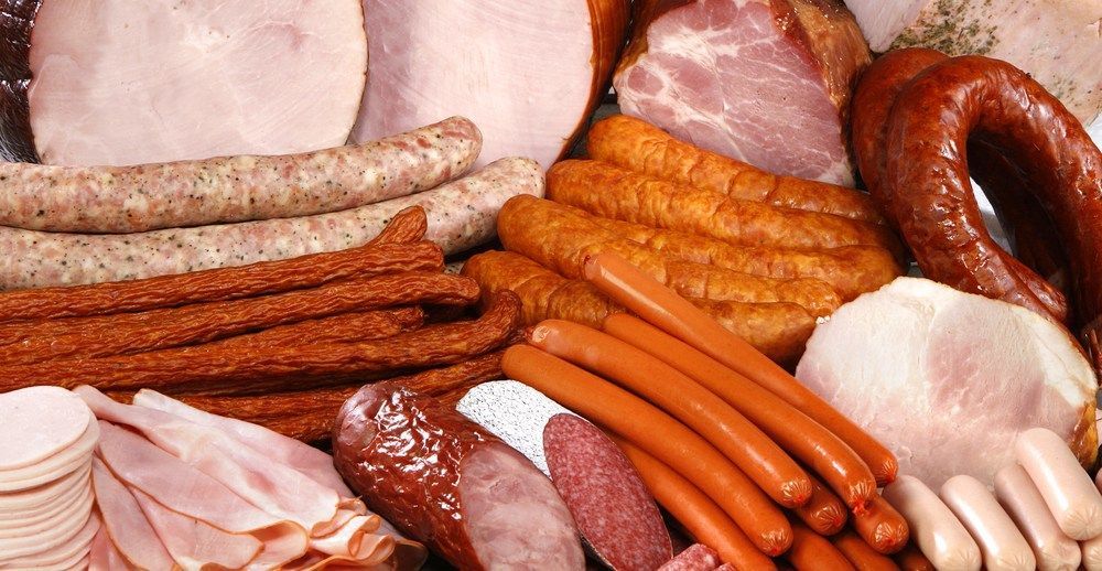 A Variety of Meats and Sausages Are on a Table — Corrado & Frank Distributors in Fairy Meadow, NSW