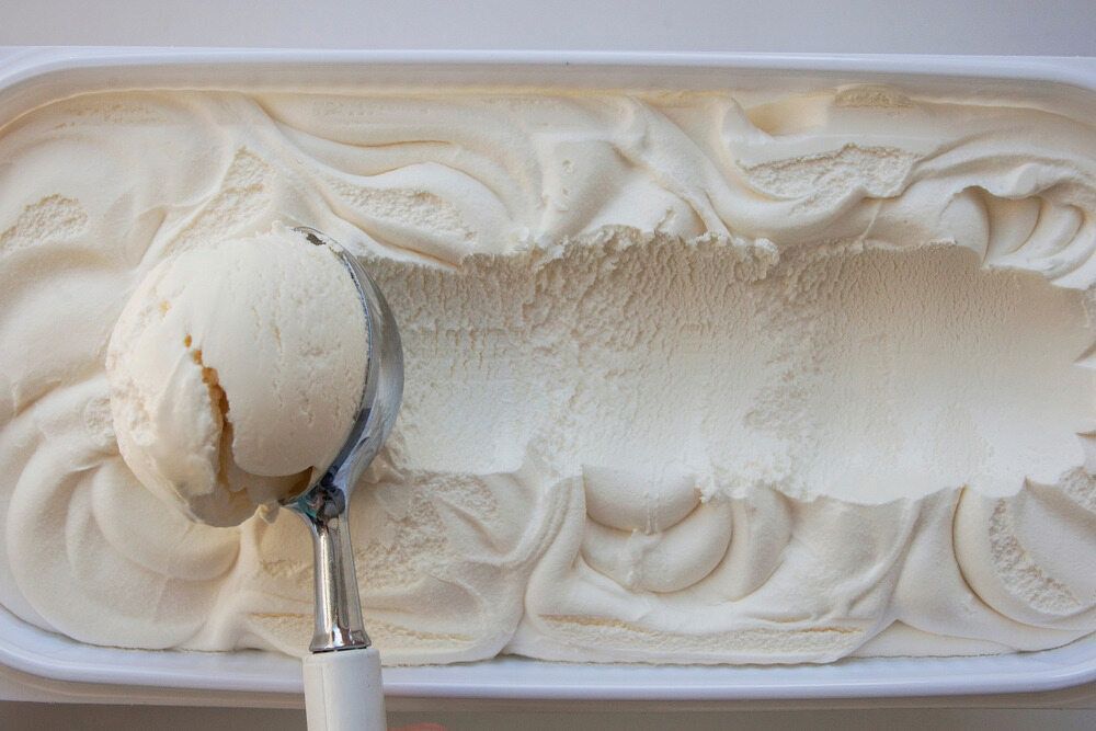 A Scoop Of Gelato Is Being Scooped Out Of A Container Of Gelato — Corrado & Frank Distributors in Fairy Meadow, NSW