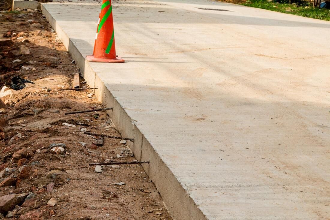 Concrete driveway needing repair. The driveway is sawcut exposing rebar ready for replacement.