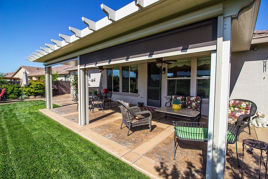 Stamped and patterned concrete patio in Maple Ridge with furniture sitting on top.