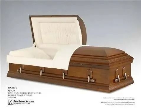 Open wooden casket, light interior, dark exterior, metallic handles.