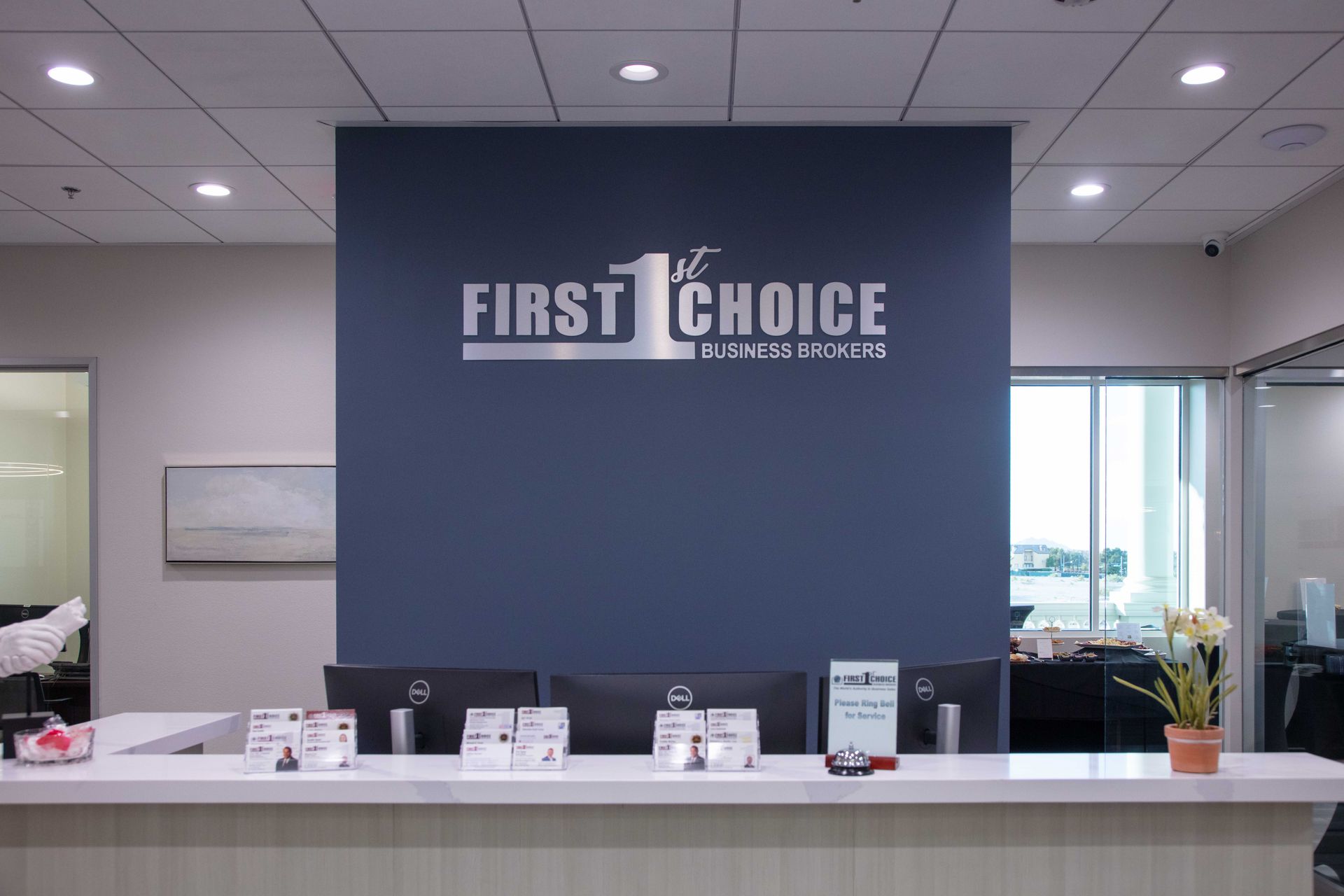 A reception desk with a sign on the wall that says `` first choice ''.