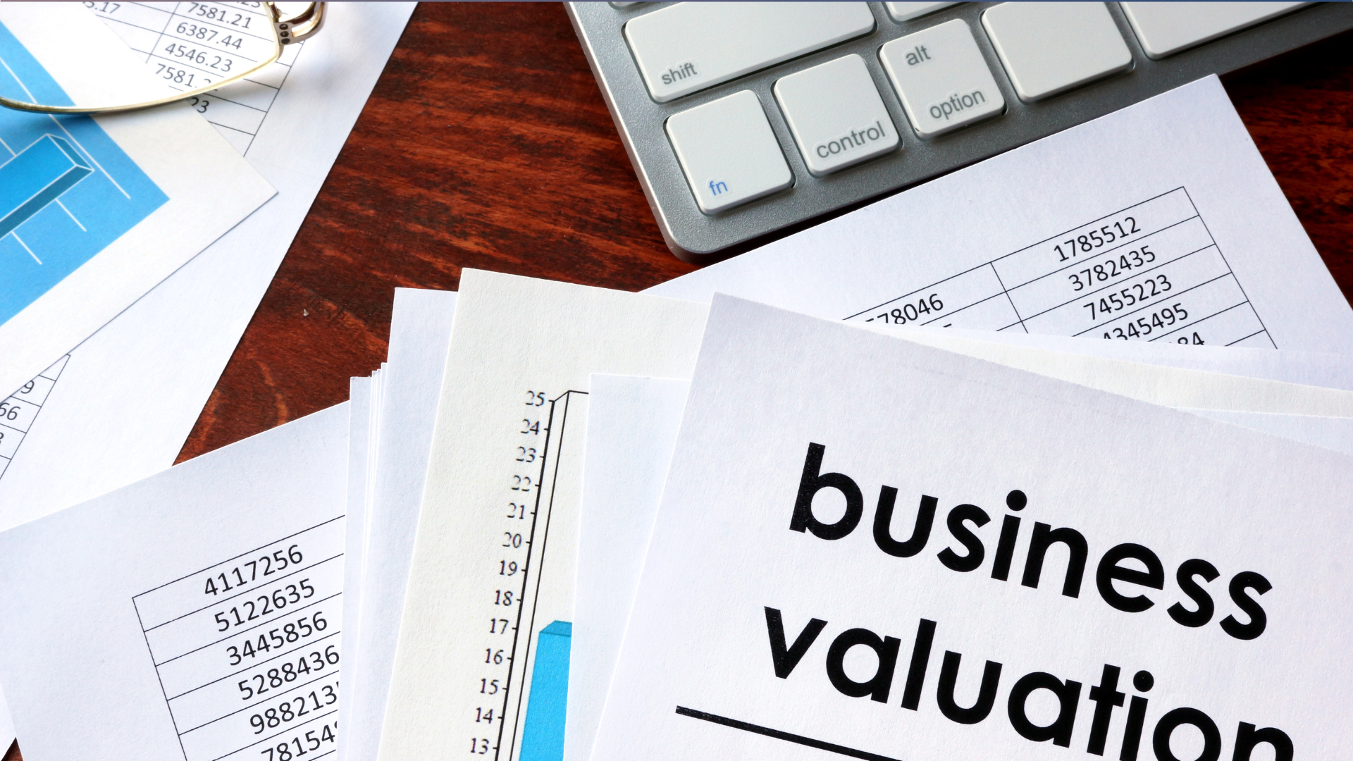 A business valuation paper is on a desk next to a keyboard