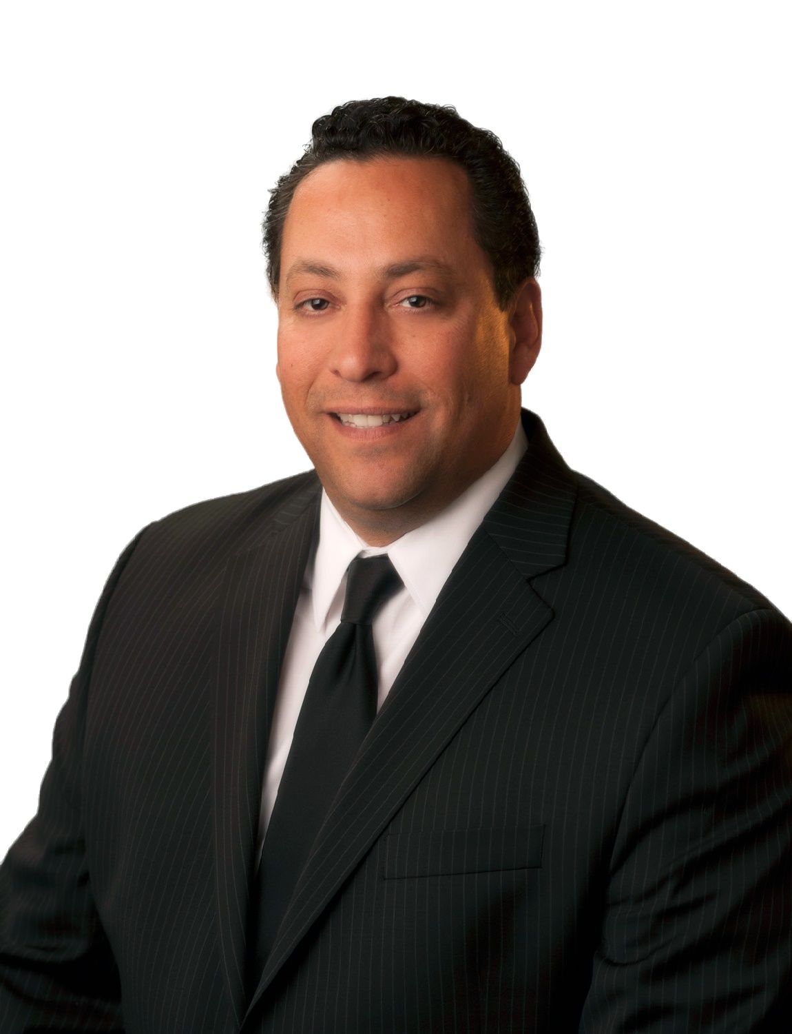 A man in a suit and tie is smiling for the camera