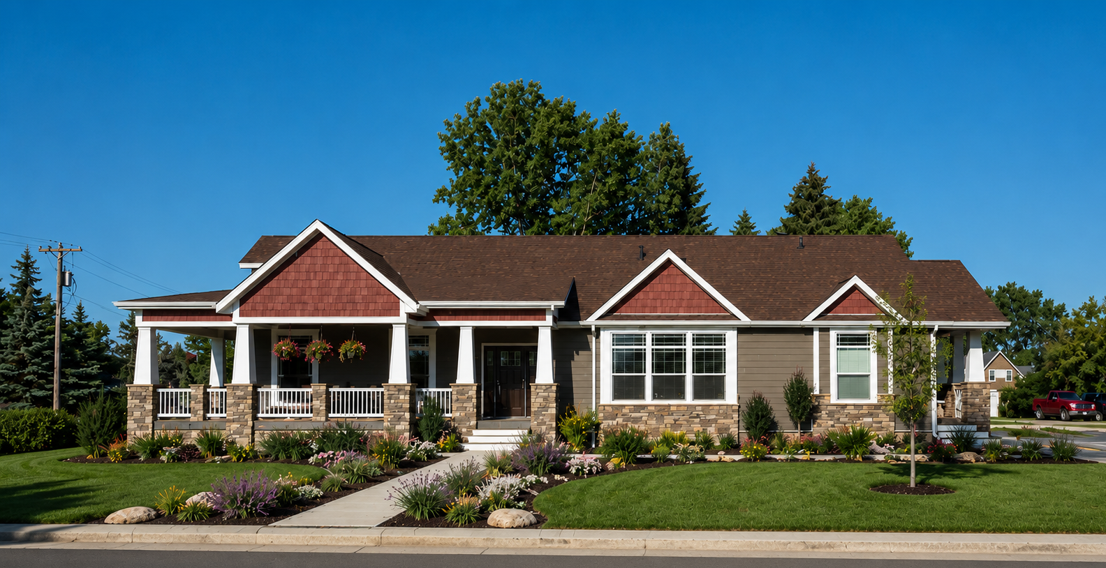 Single-story brick house with white trim, front porch, landscaped garden, and driveway under a blue sky