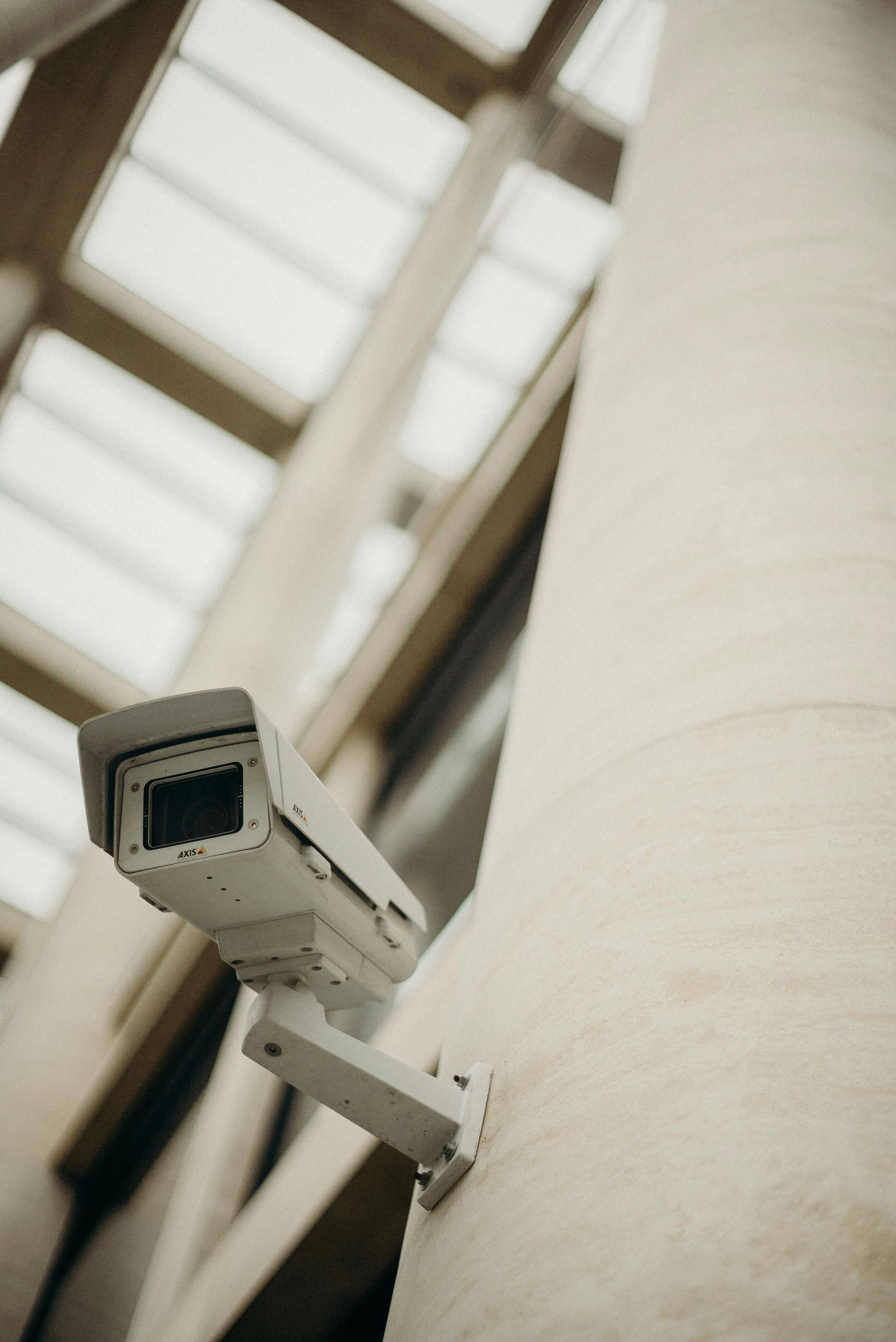 Two security cameras are mounted on the side of a building.