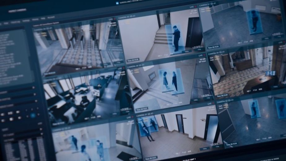 A computer monitor with a bunch of security cameras on it.