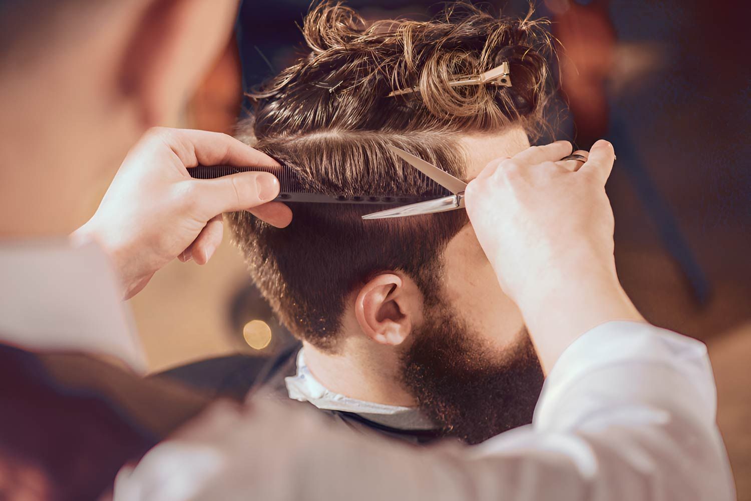 A Man With A Beard Is Getting His Hair Cut — Arabella Hair Design in Sebastopol, VIC