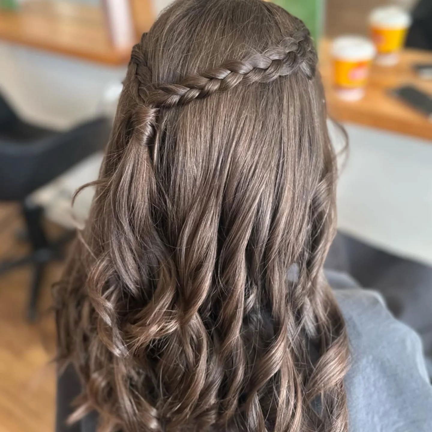 Half-up braided hairstyle with loose curls styled by Ballarat Hairdressers.