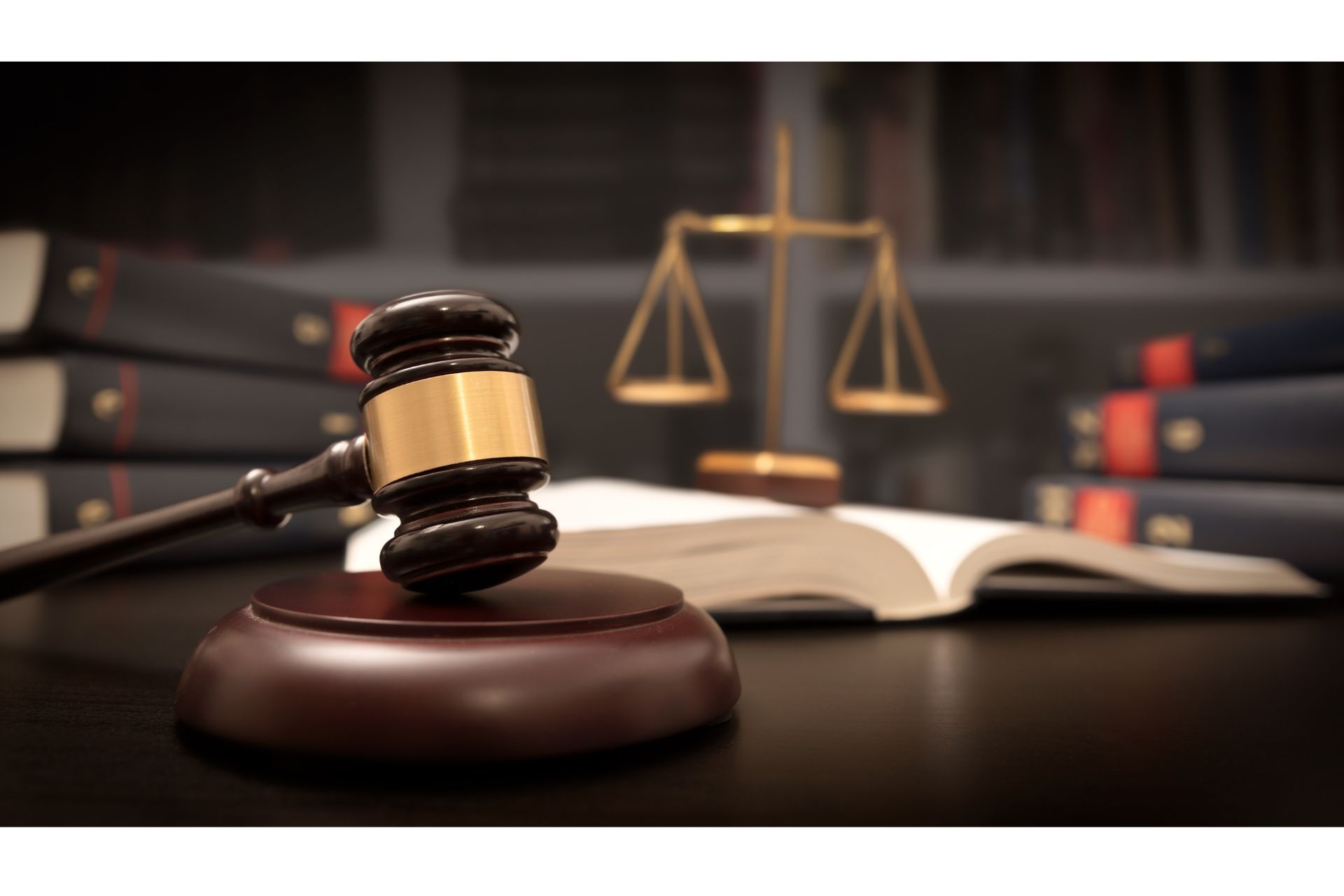 A judge 's gavel is sitting on a table next to a scale of justice.