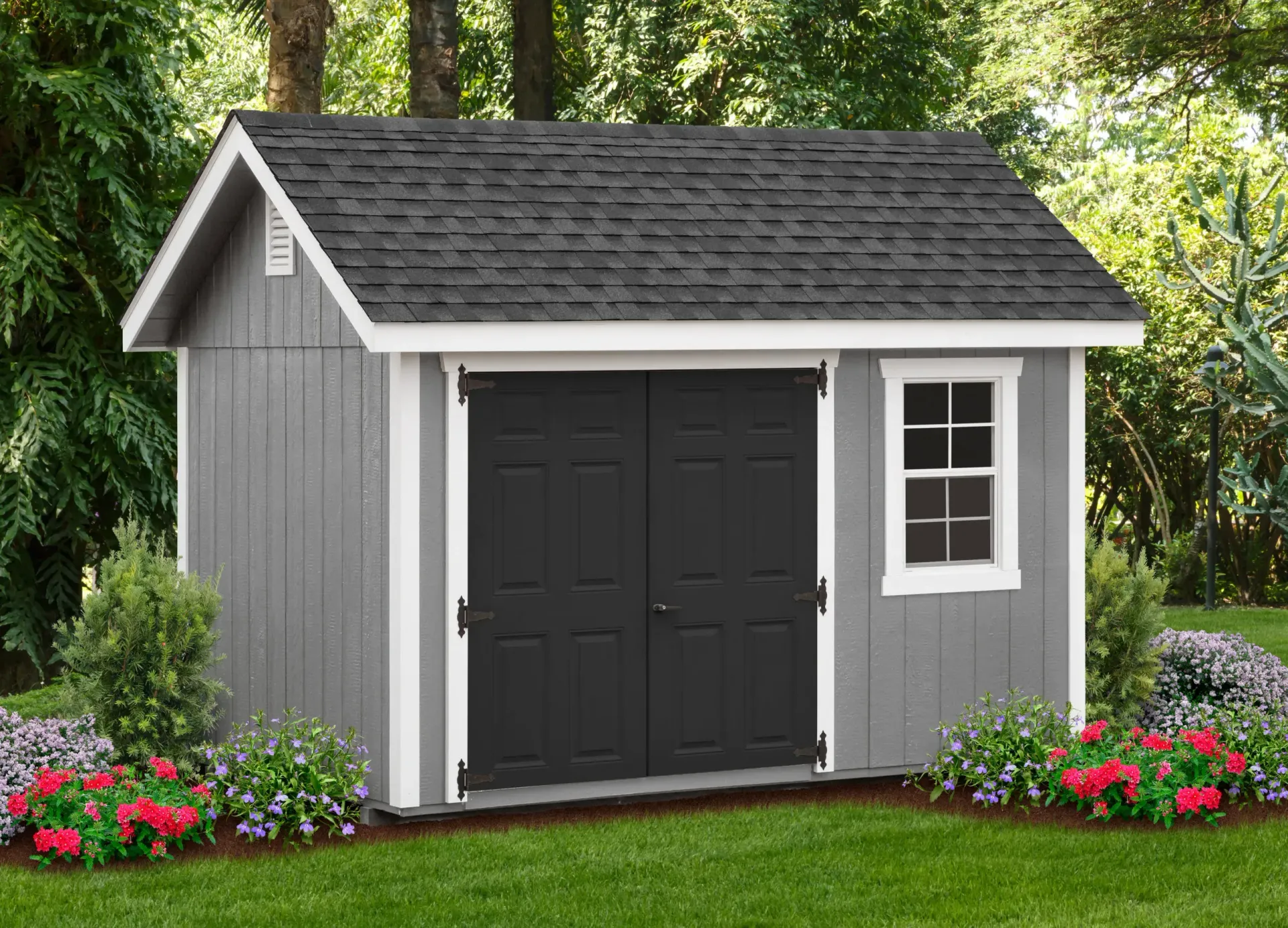 Gray shed with black doors, window, and dark roof in a garden.