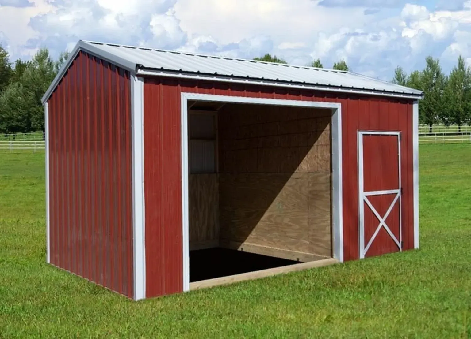 Red and white metal animal shelter structure with open entrance and a small door, set in a grassy field.