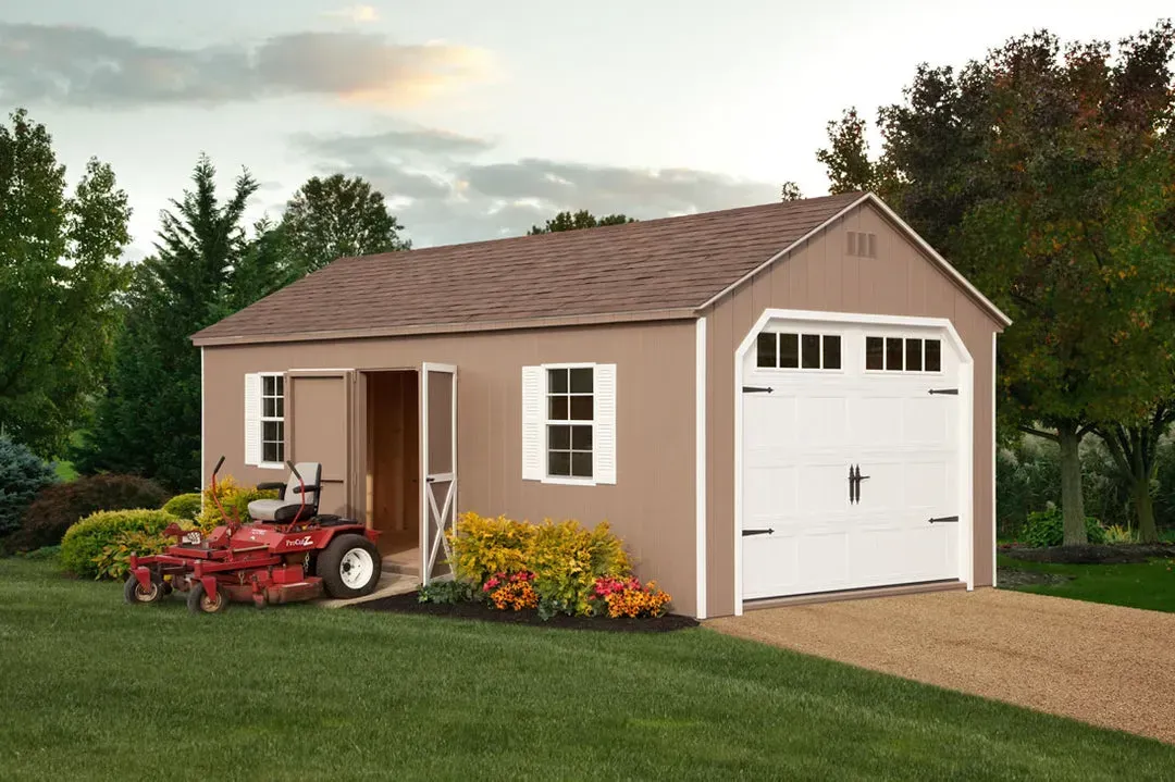 Tan shed with brown roof, white garage door, open side door, lawnmower, gravel driveway.