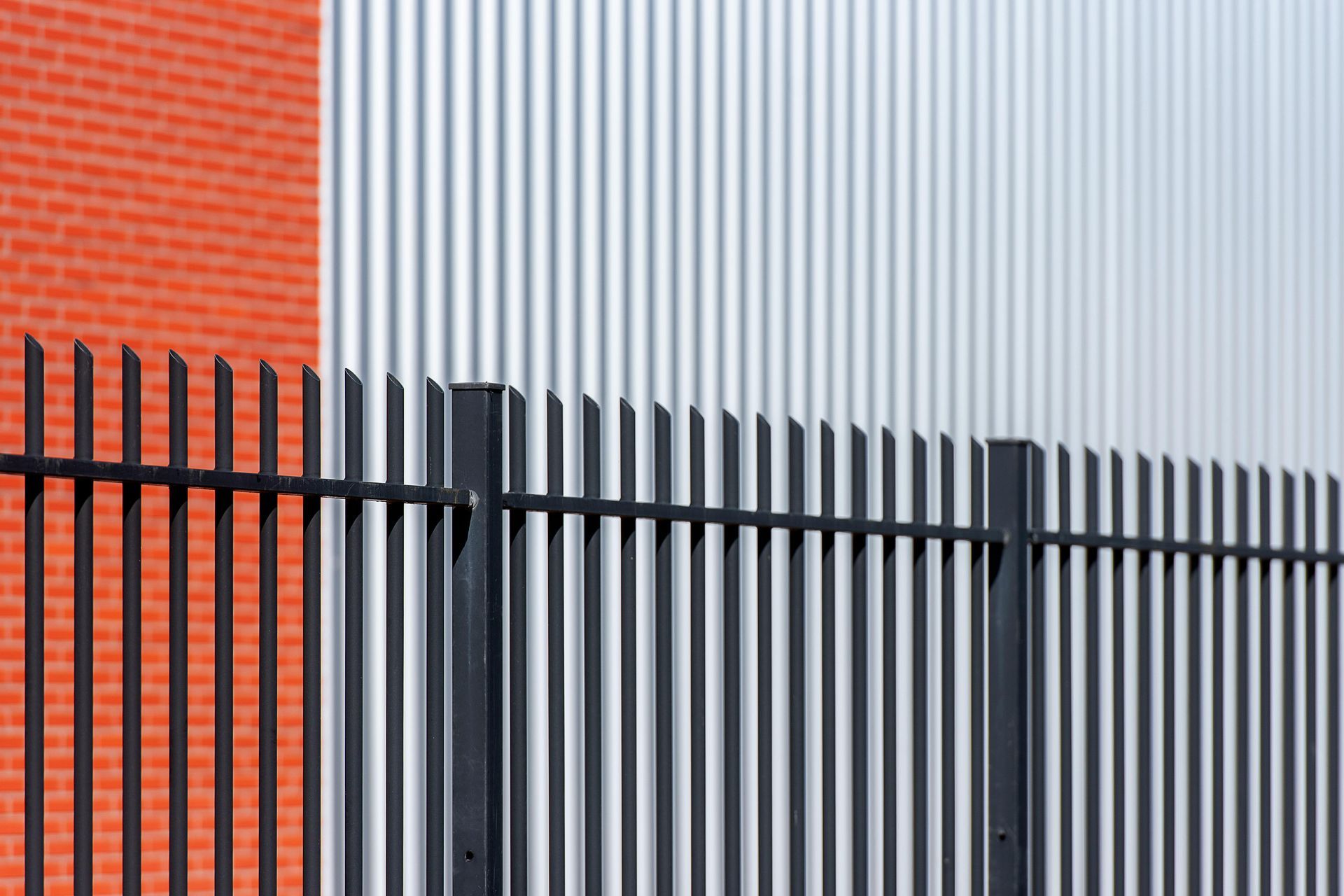 A close up of a chain link fence with trees in the background.