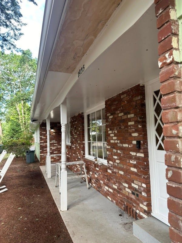 Red brick house with white trim, covered porch, and address number 1939.