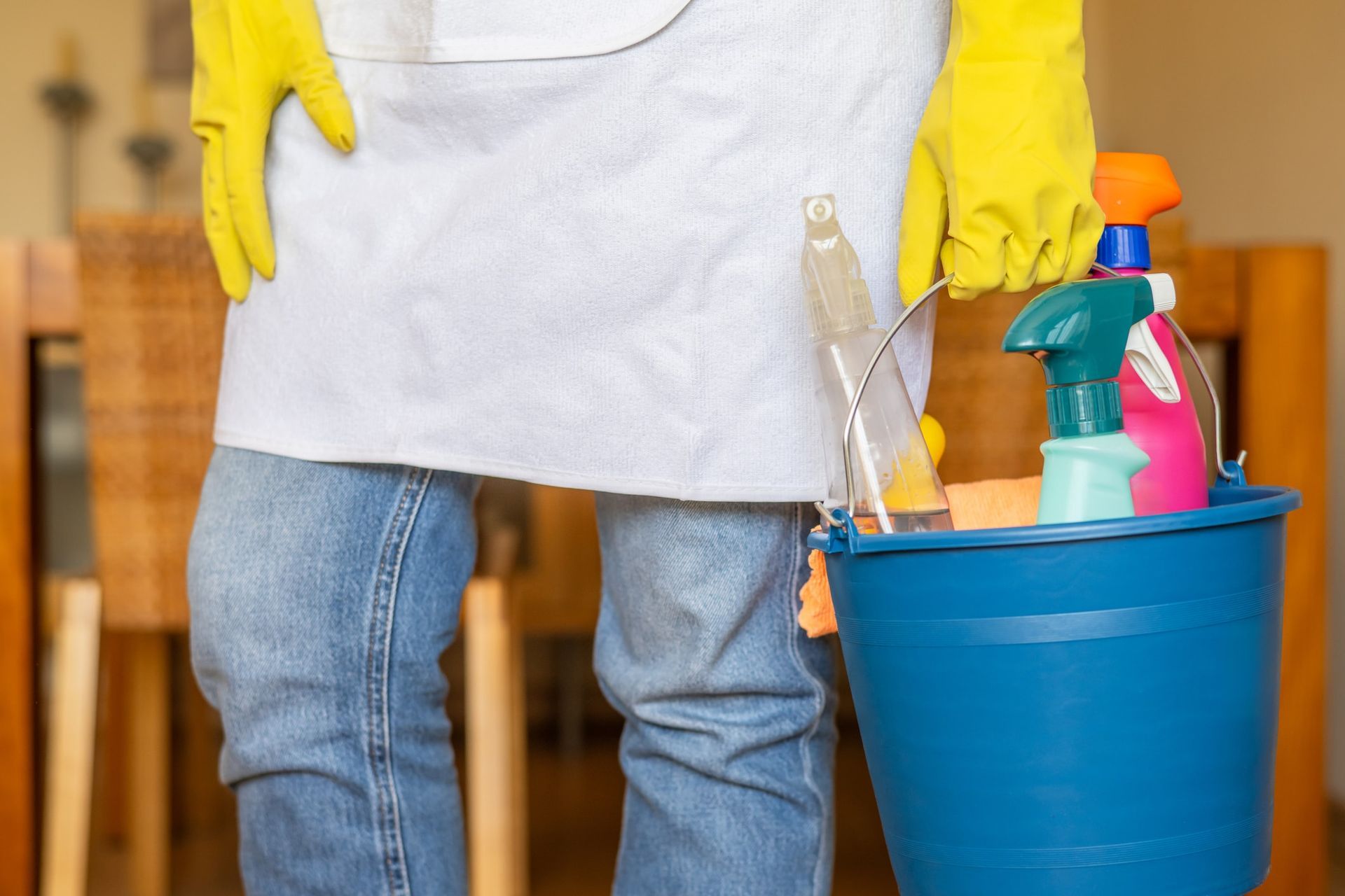 Essential cleaning supplies for spring cleaning, including microfiber cloths and dish soap.