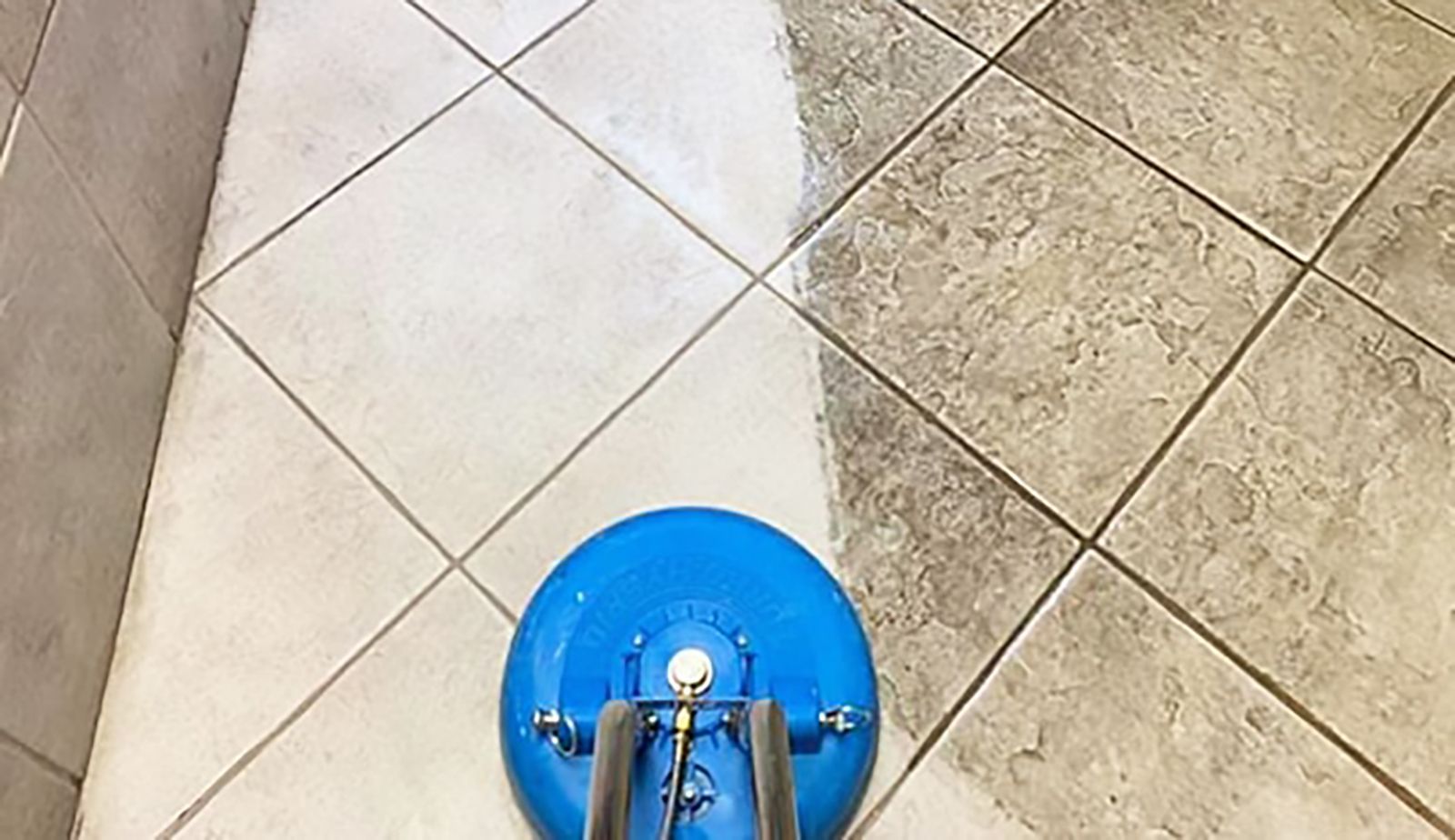A tile floor is being cleaned with a machine.