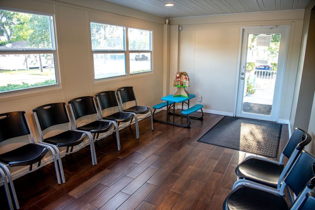 A waiting room with rows of chairs and a picnic table.