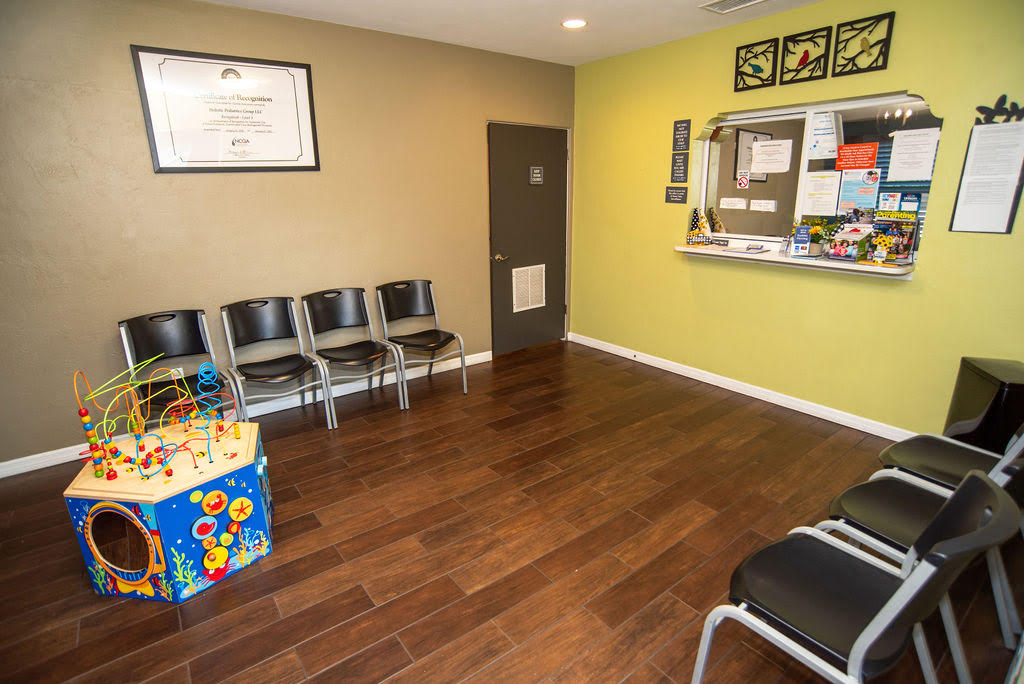 A waiting room with chairs and a toy in the middle