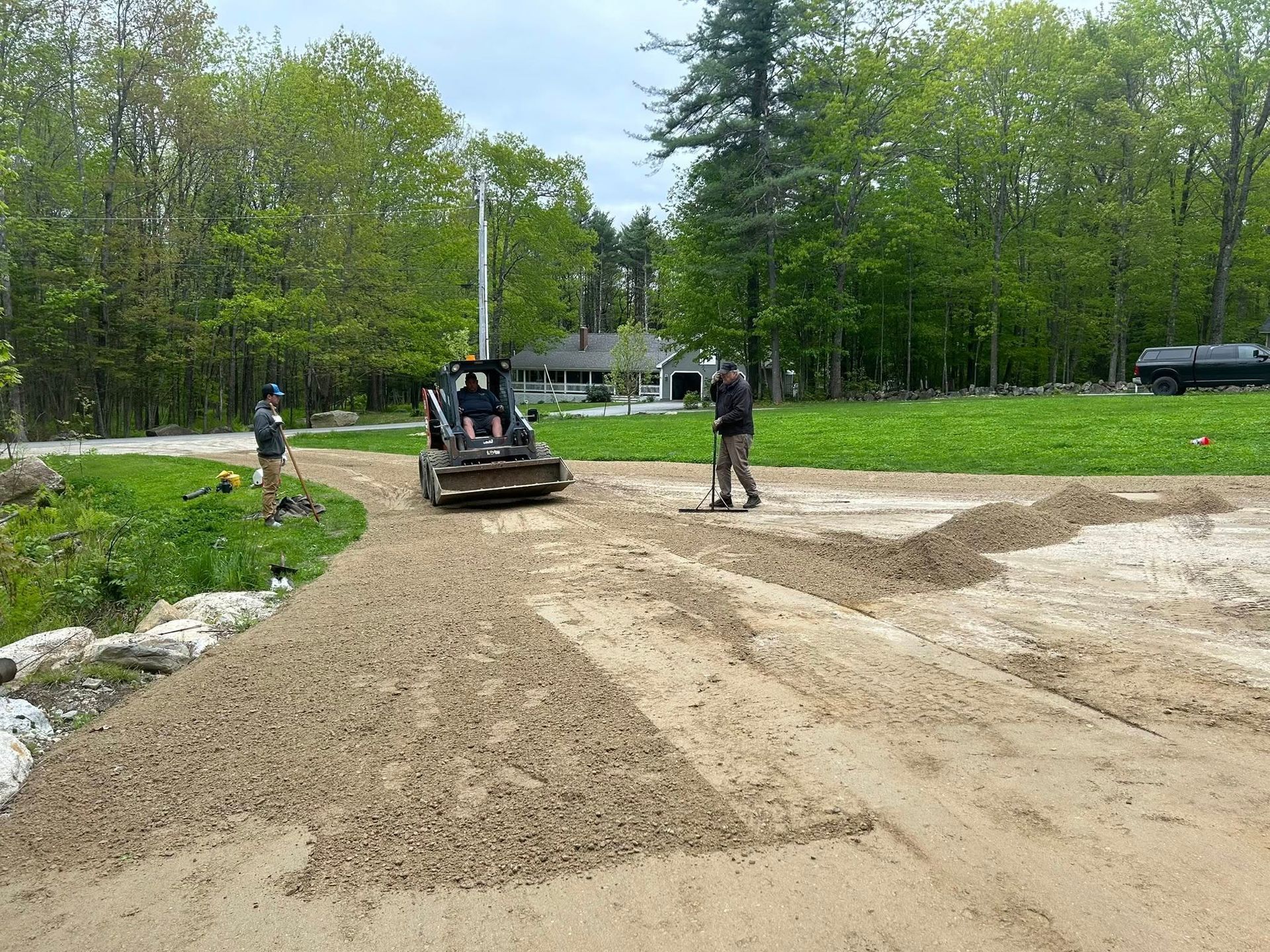 A man is standing next to a bulldozer on a dirt road.