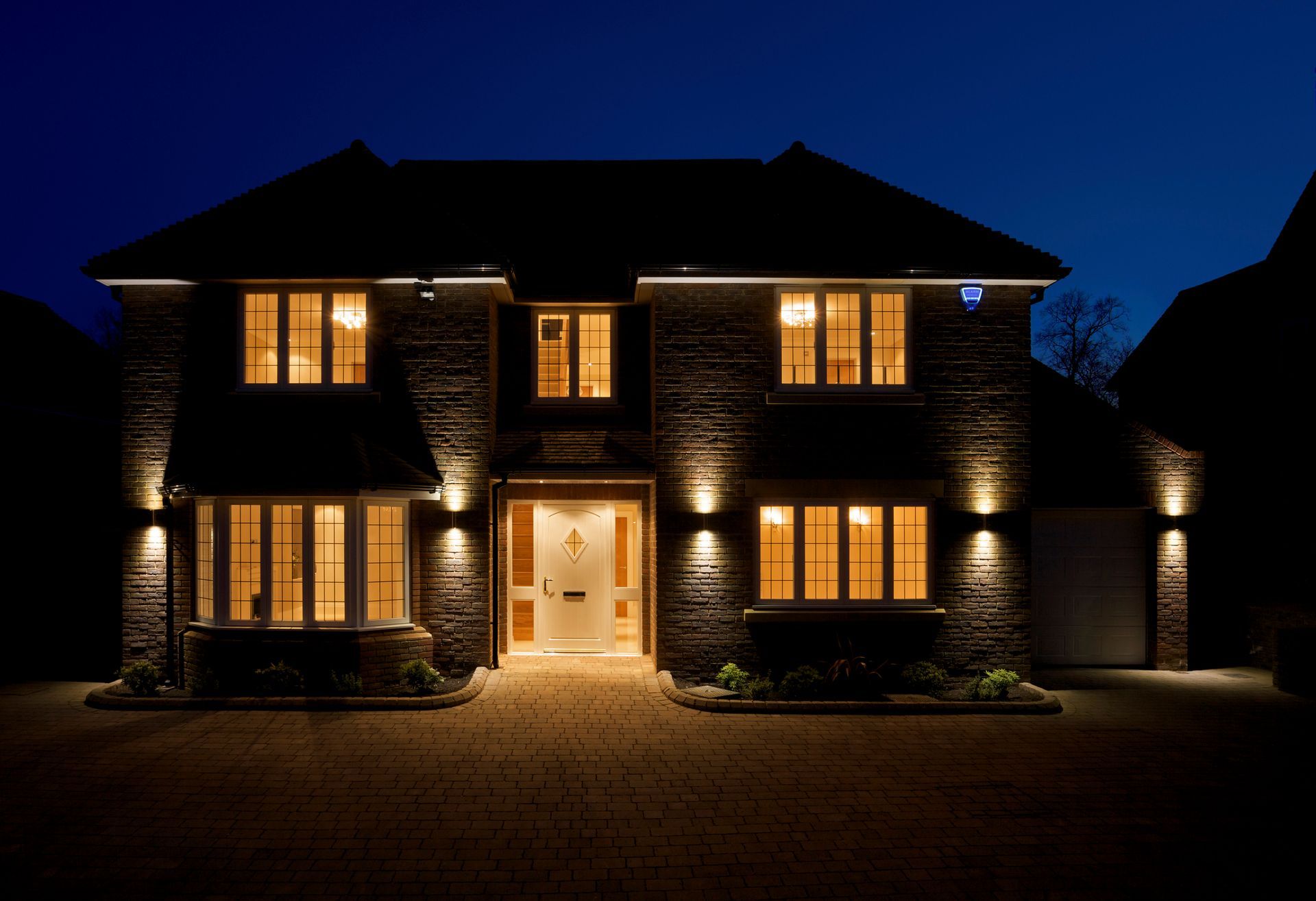 The front of a house is lit up at night