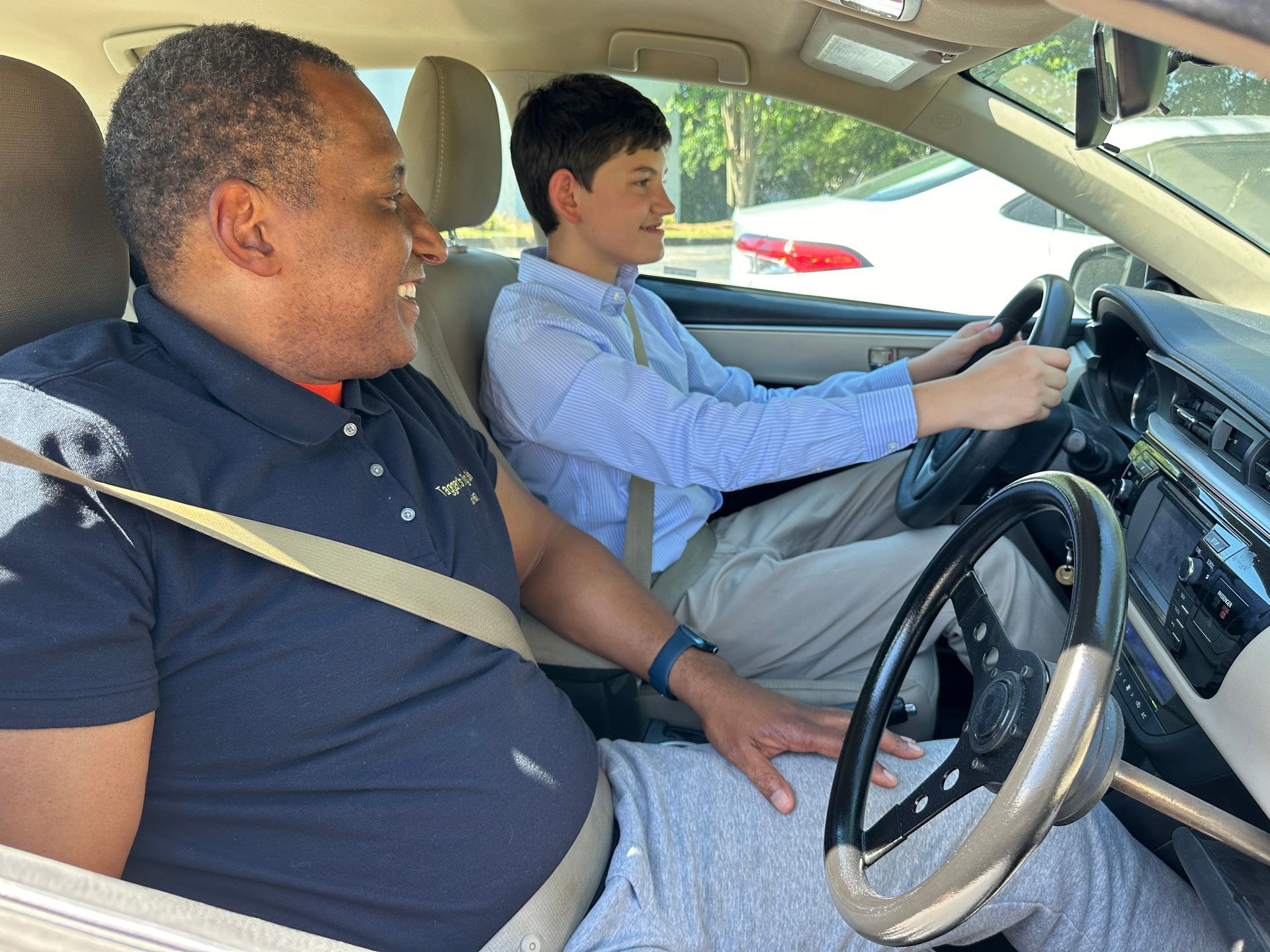 A man is sitting in the driver 's seat of a car.