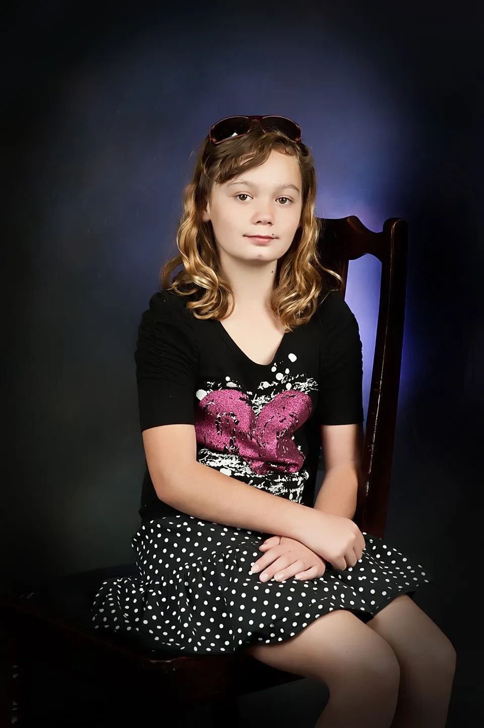 A Young Girl with Curly Blonde Hair in Photo Studio