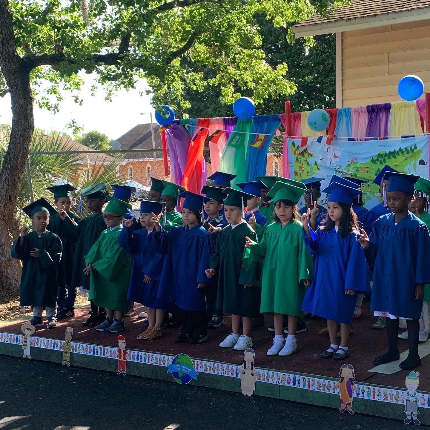 A group of children wearing graduation caps and gowns