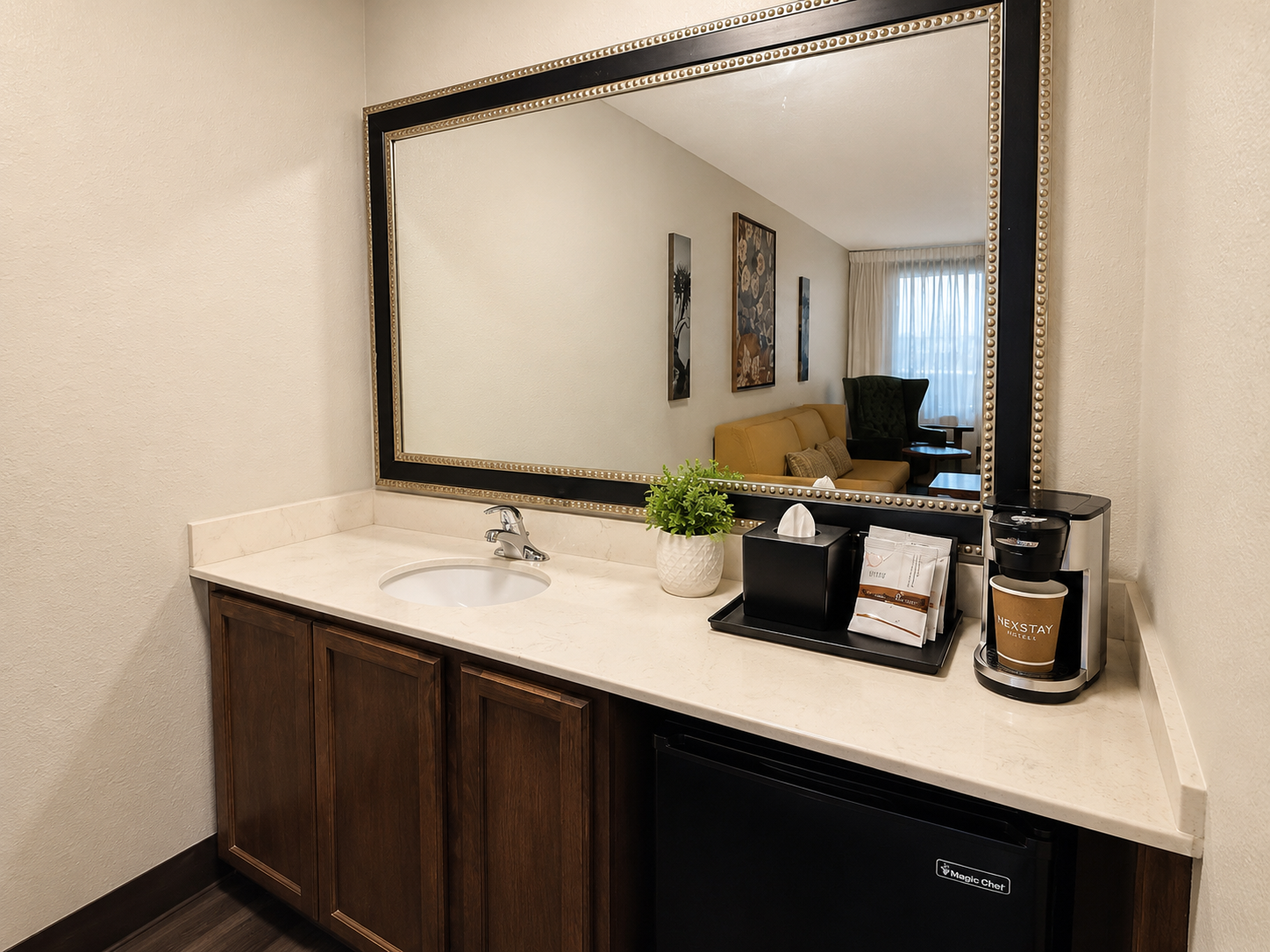 Bathroom vanity with large mirror, dark wood cabinets, white countertop, sink, and decorative items