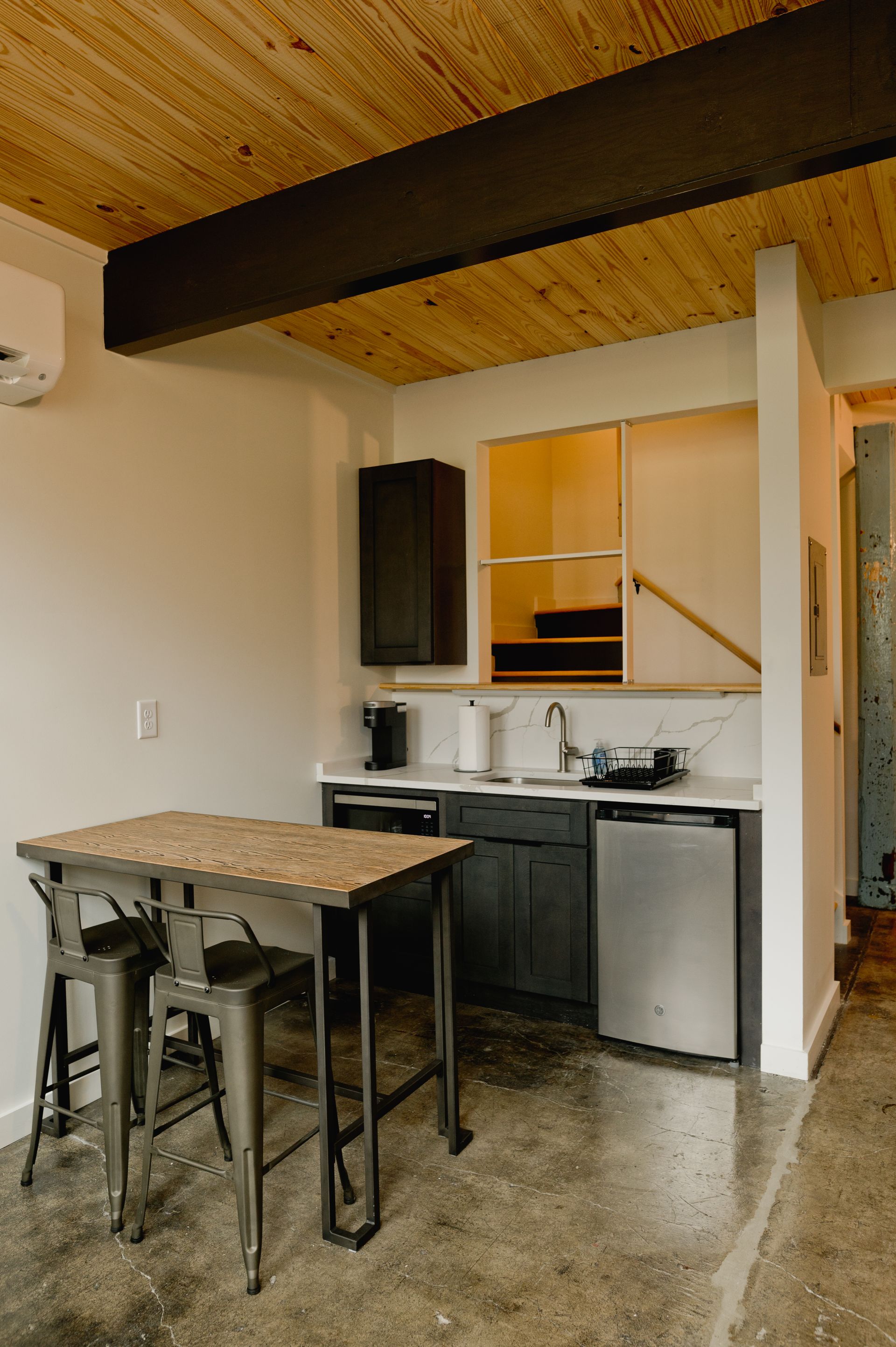 Boutique hotel kitchenette with bar table and appliances