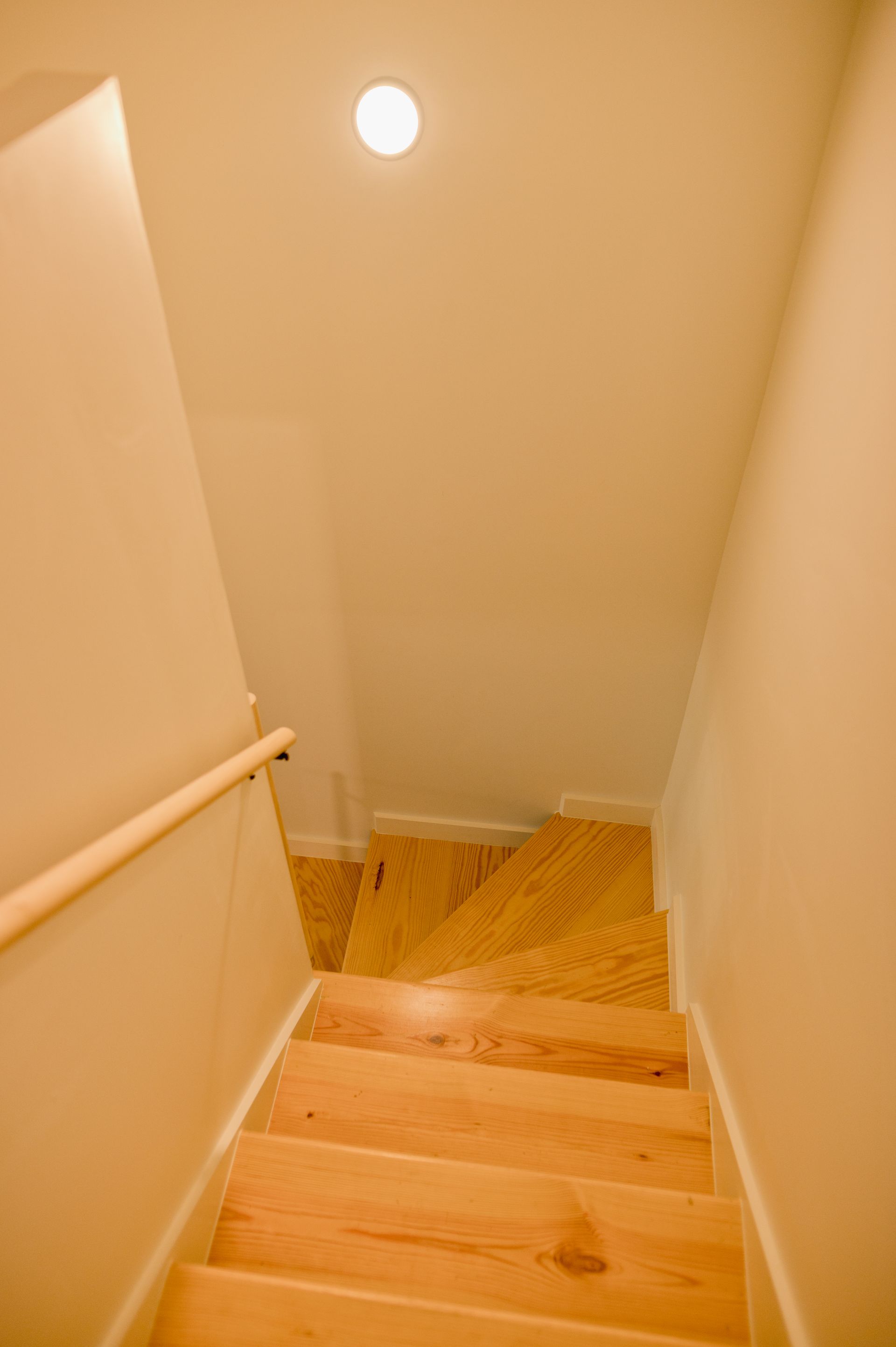 Loft boutique hotel room with wooden staircase