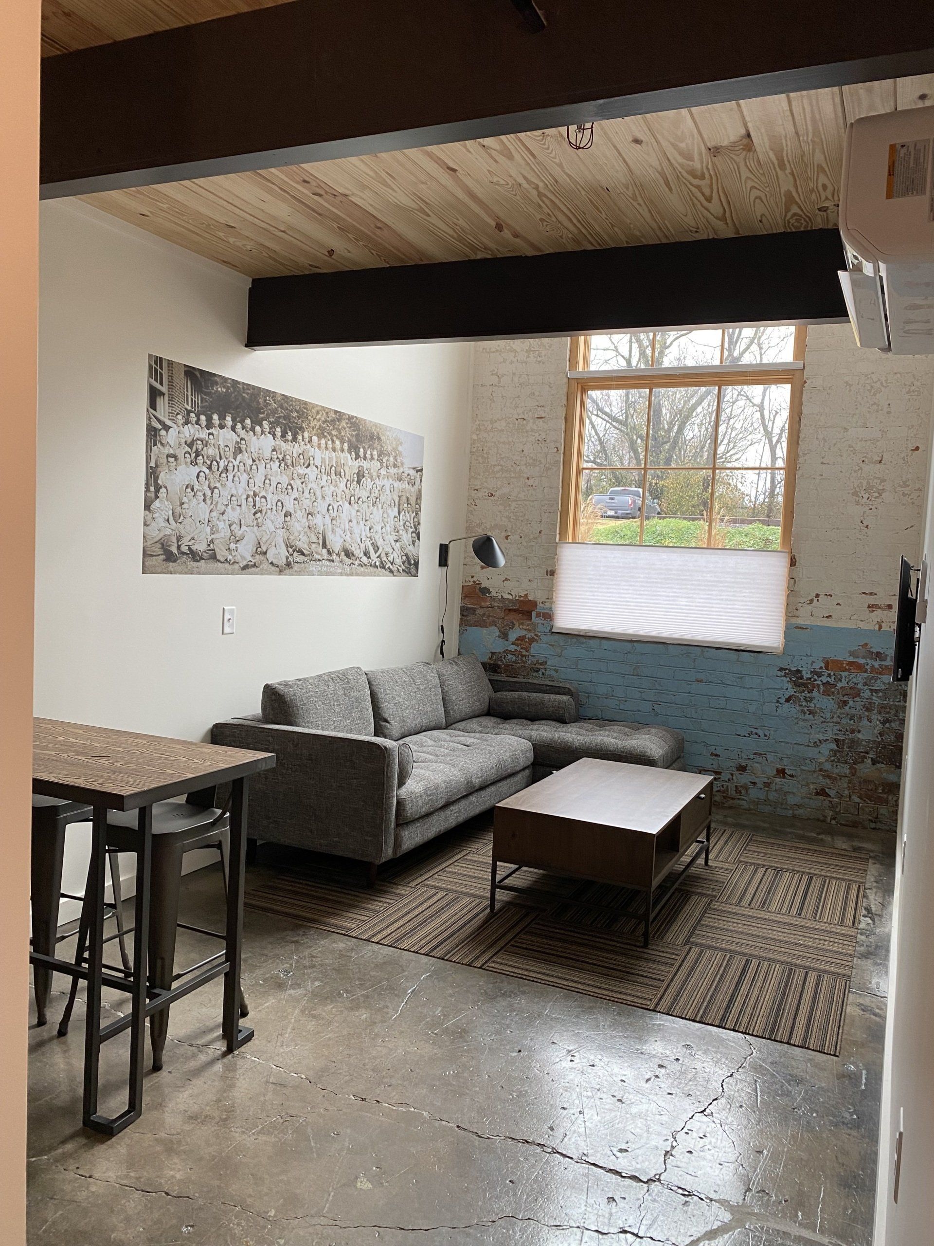 Full view of suite seating area with exposed brick