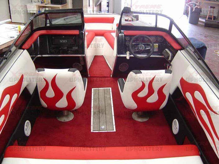 Interior of a red-and-white speedboat with flame decals and two cockpit seats