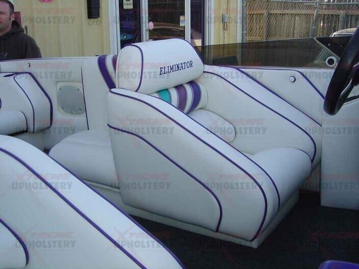 White car interior with purple-striped custom upholstery and ELIEZER logos on the seats
