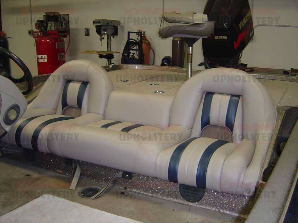 White and gray inflatable sports seat with blue stripes in a workshop or garage setting