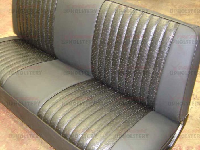 Gray and metallic vinyl diner booth with ribbed chrome trim and padded bench seating