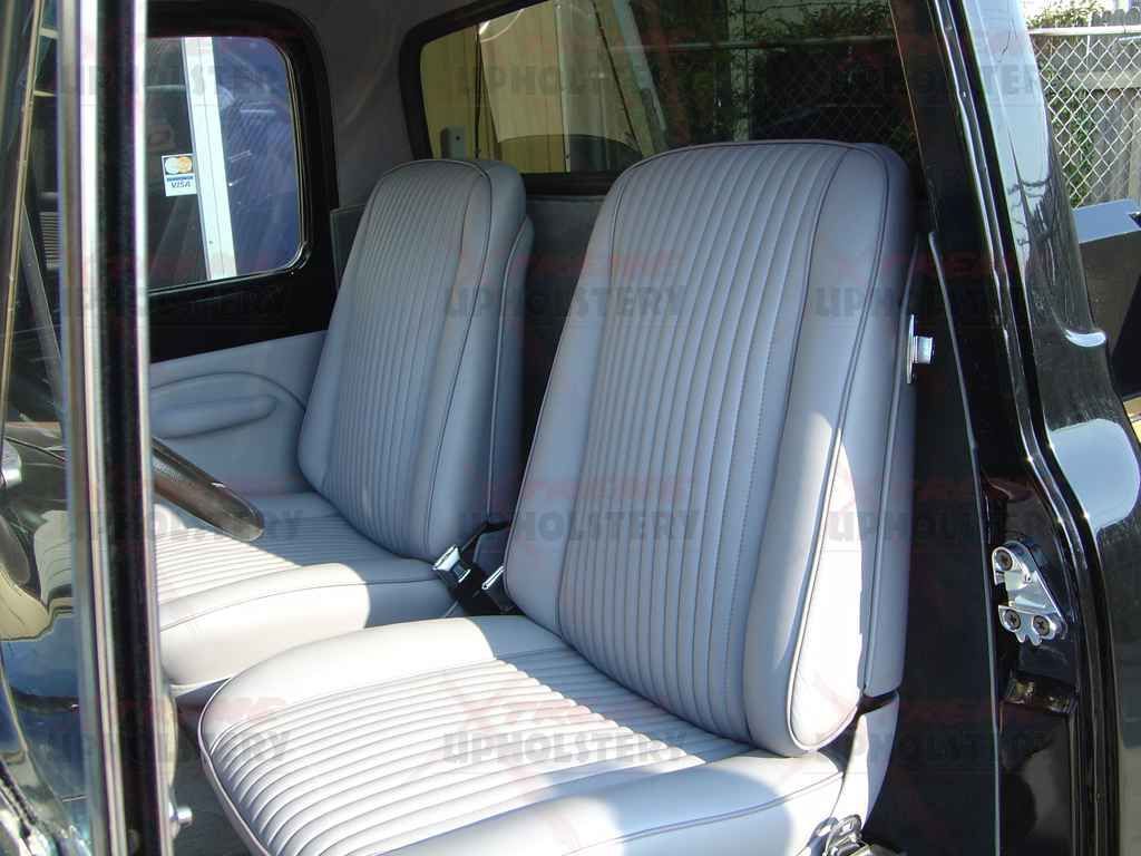 Interior of a car with gray striped front seats viewed through the open door