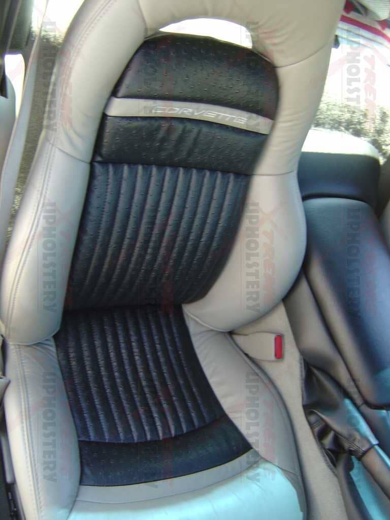 Car seat with black ribbed upholstery and gray side bolsters inside a car interior