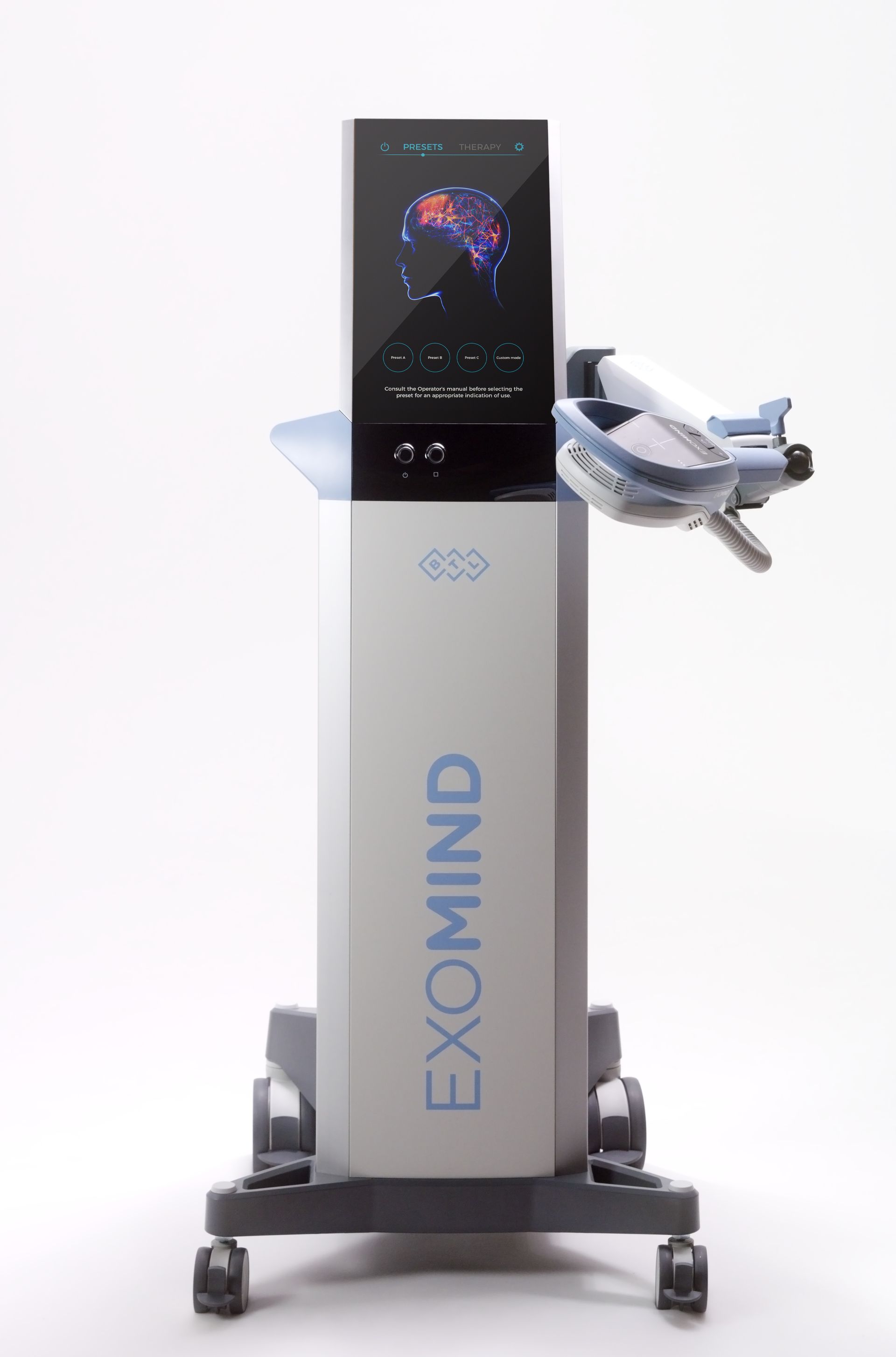 EXOMIND medical device, a tall gray machine with a display showing a colorful brain scan and an attached robotic arm.