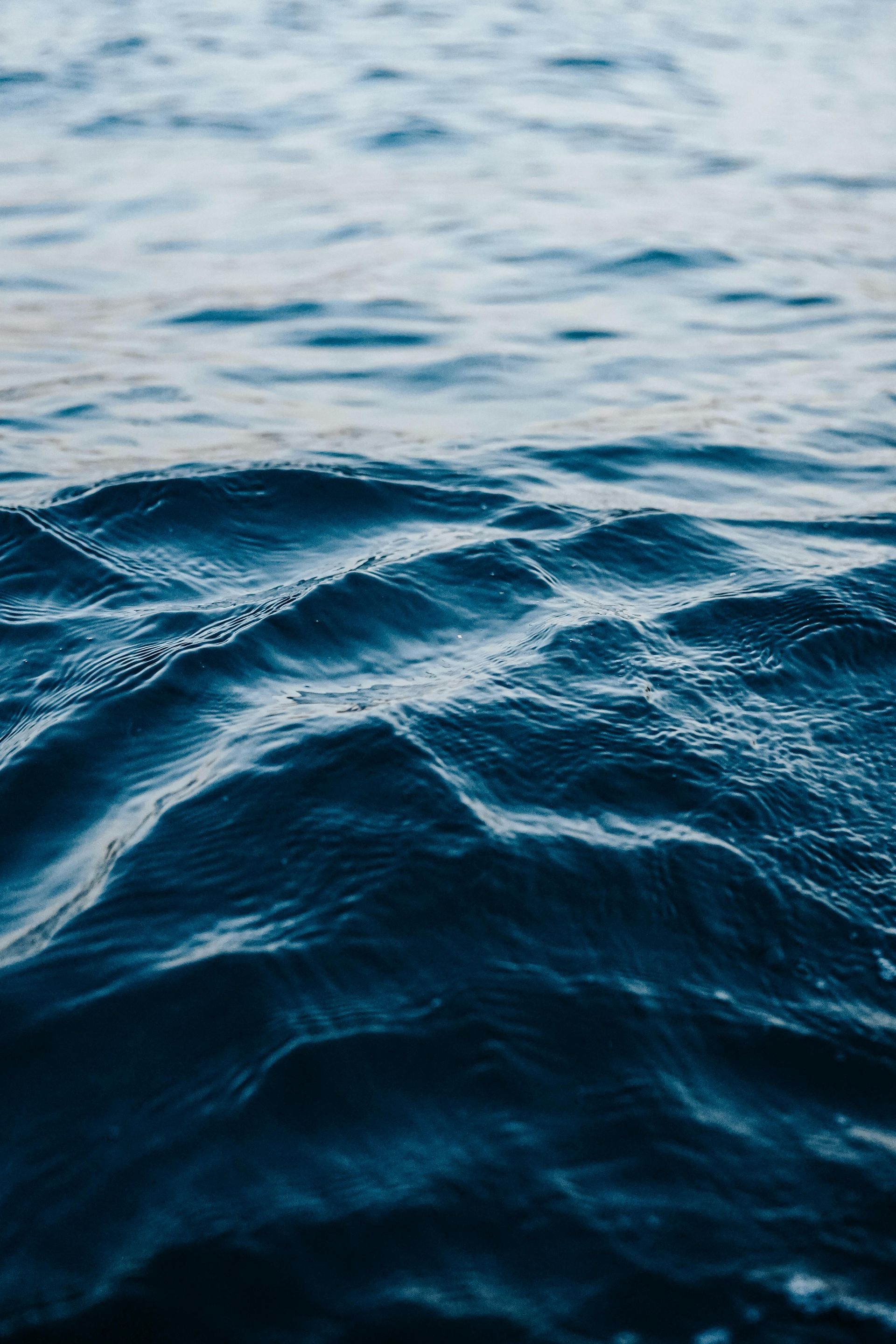 Blue ocean water, rippling waves in natural light.