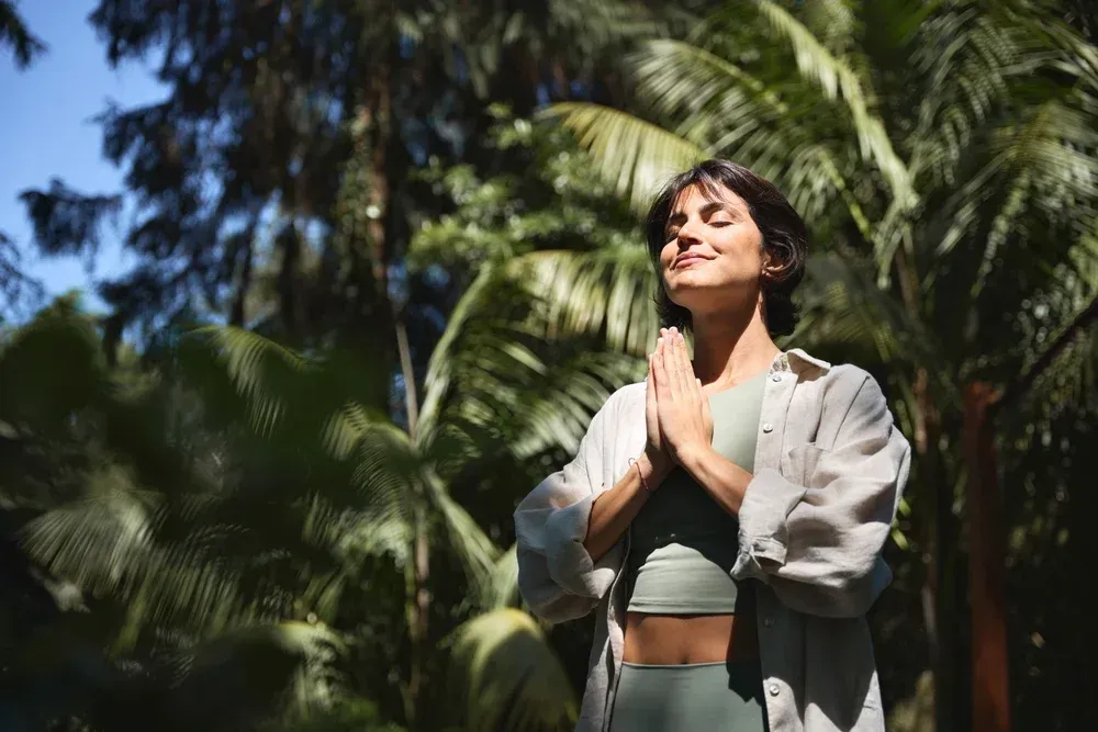A girl feeling serene in nature.