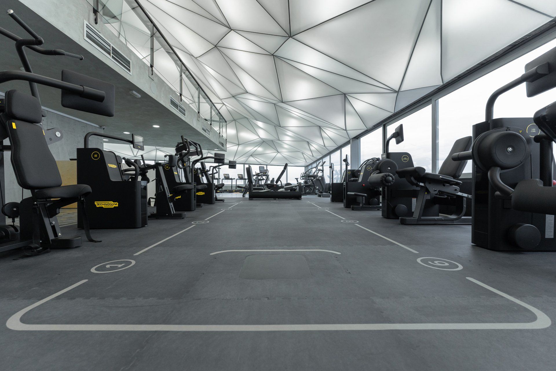a large empty gym with a lot of exercise equipment .