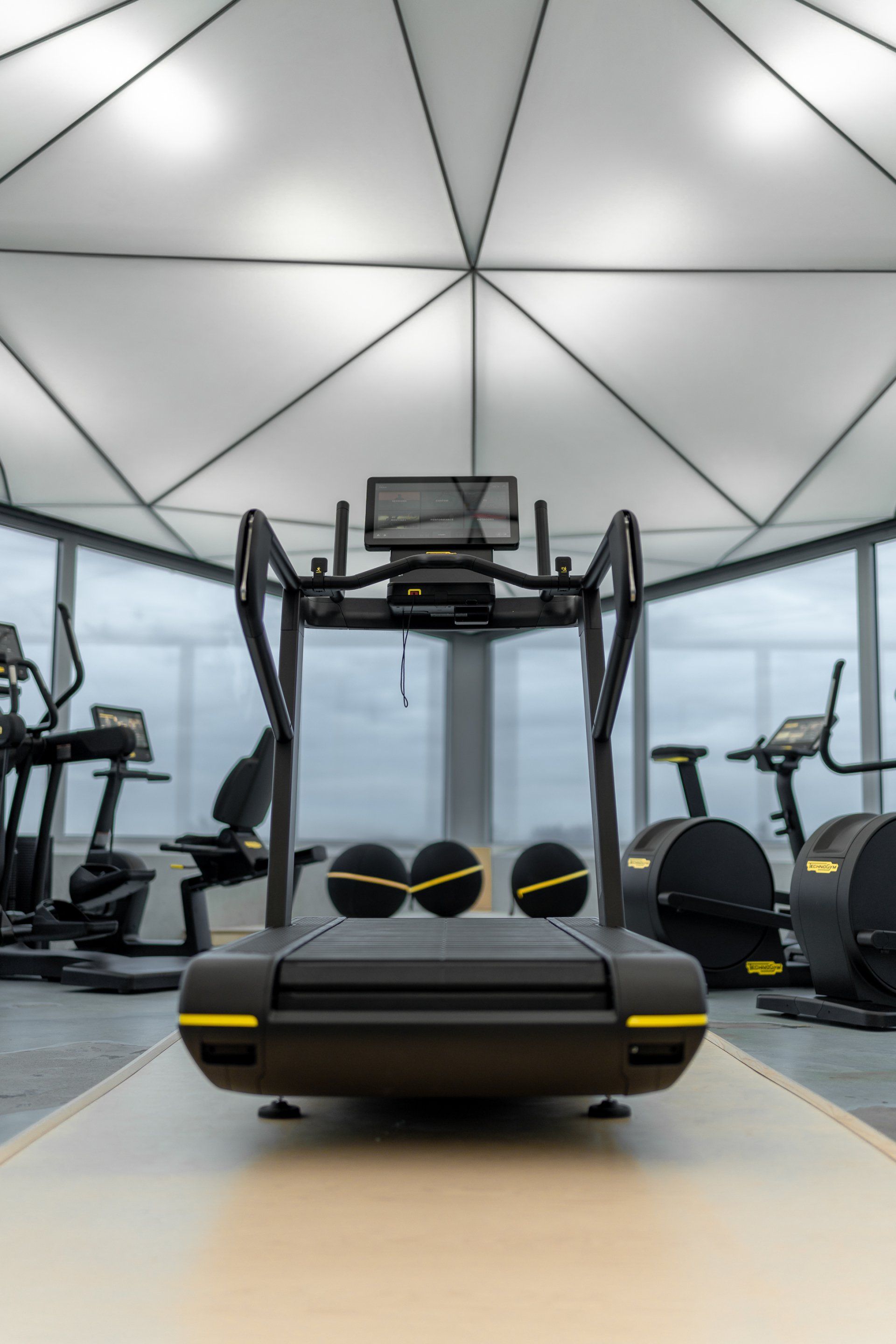 a Skillrun treadmill in the middle of a gym .