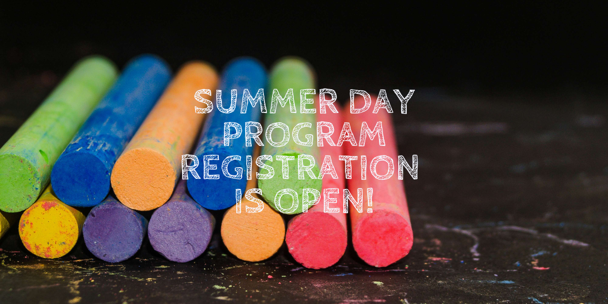 Colorful chalk arranged on a dark surface, with text stating