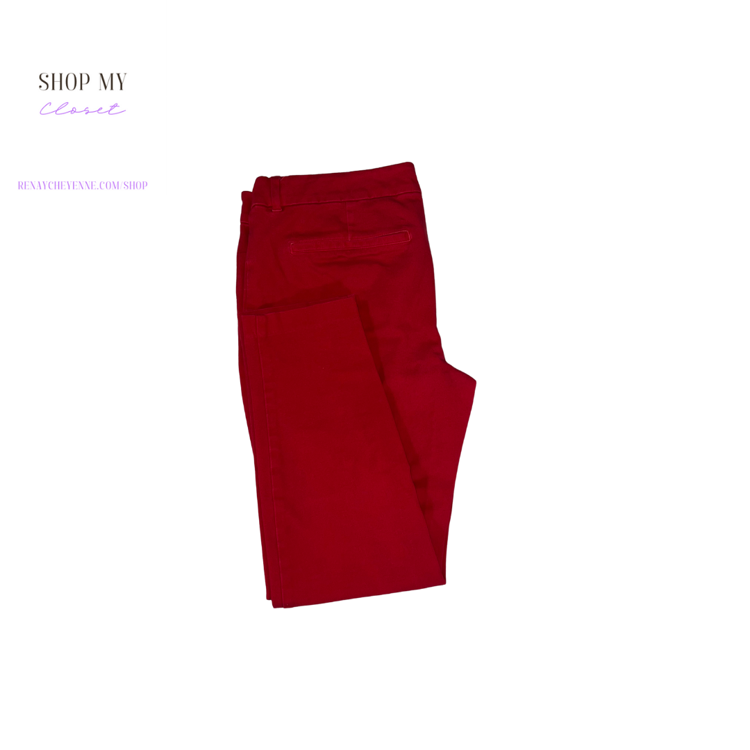 A pair of red ankle stretch pants from Old Navy. The pants are size petite 12 and have a high-rise waist, a slim fit, and a tapered leg. The fabric is a soft, stretchy cotton blend that is comfortable to wear all day long. The pants are perfect for a variety of occasions, from a day at the office to a night out on the town.