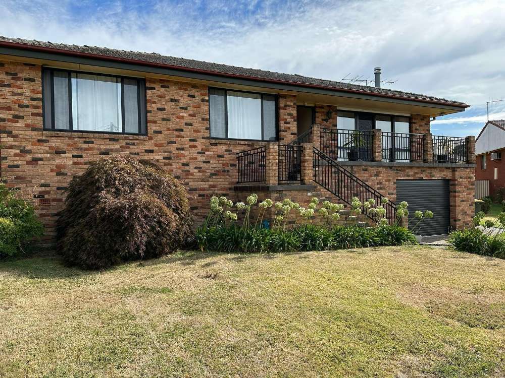 A Large Brick House With a Balcony and Stairs — Bespoke Doors & Windows in the Southern Highlands, NSW