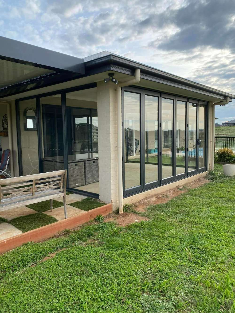 A House With a Lot of Windows and a Bench in Front of It — Bespoke Doors & Windows in the Southern Highlands, NSW