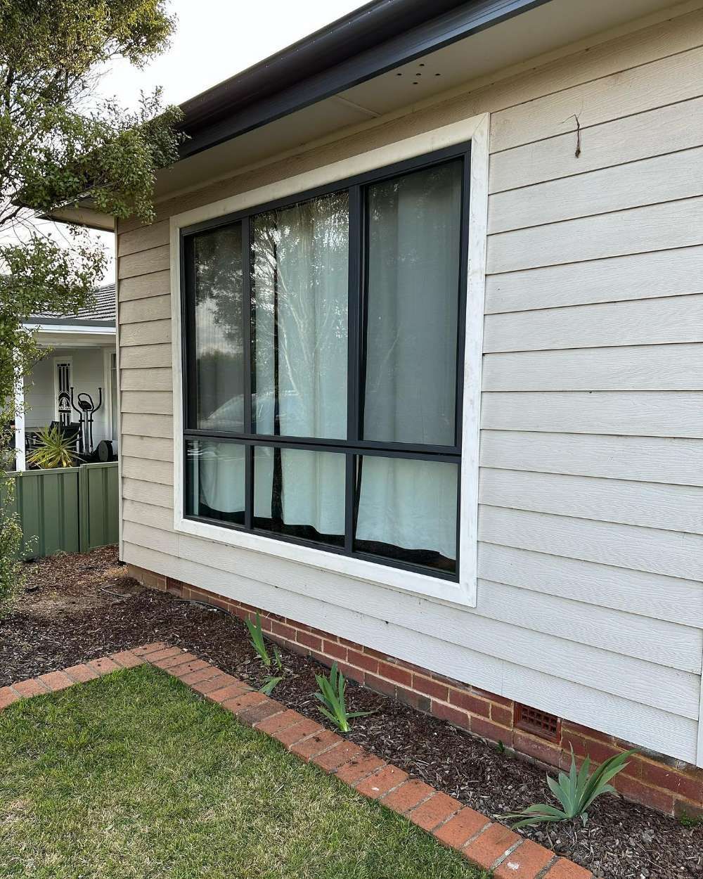 A White House With a Black Window and White Curtains — All Things Windows & Doors in Goulburn, NSW
